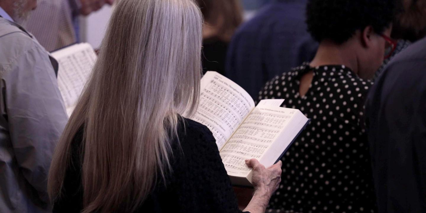 Congregation singing hymns, view of hymnals