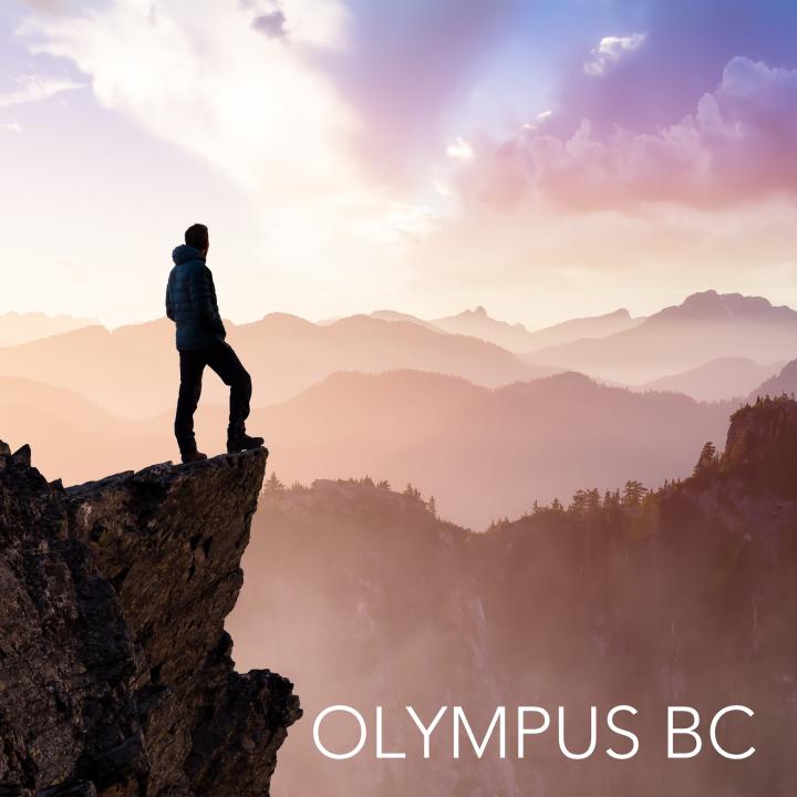 man standing on top of a mountain