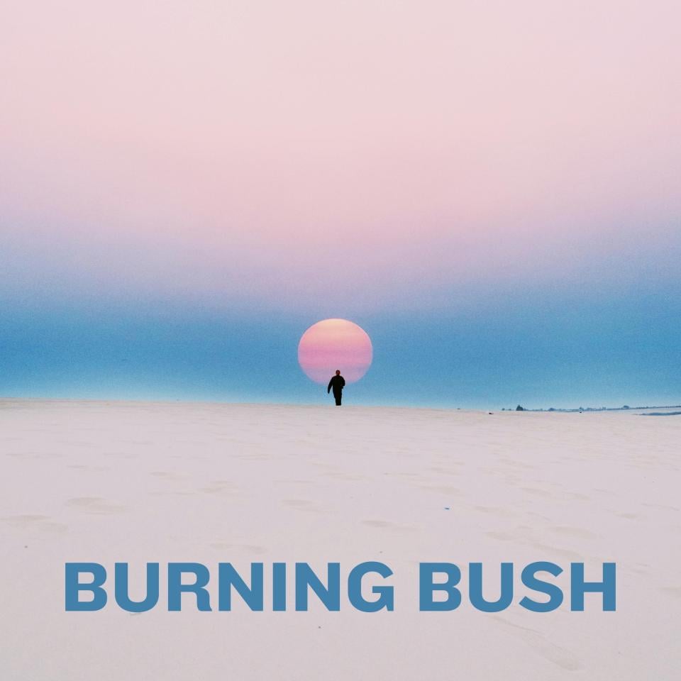 person walking in the desert at sunrise