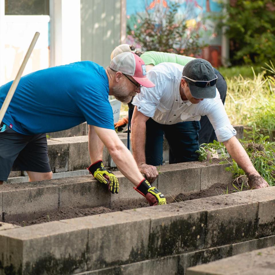 Two volunteers restoring a garden plot