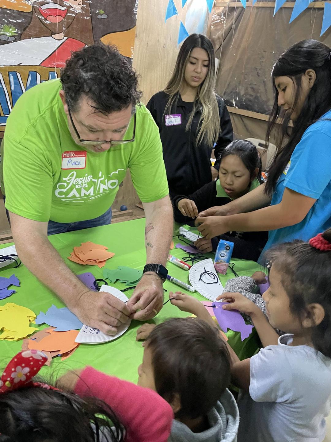 Volunteer working with children during mission trip