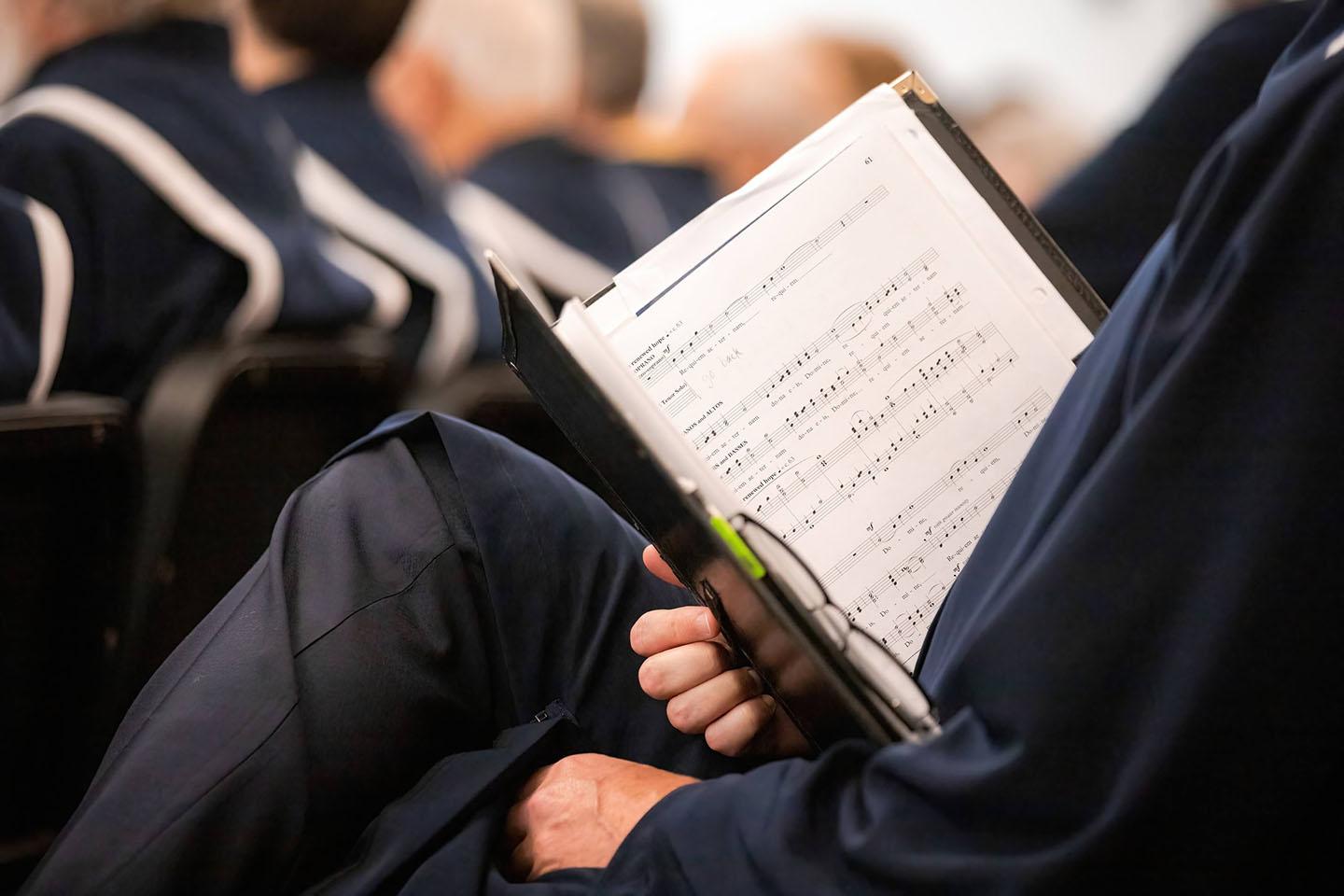 Close up of sheet music in a choir member's lap